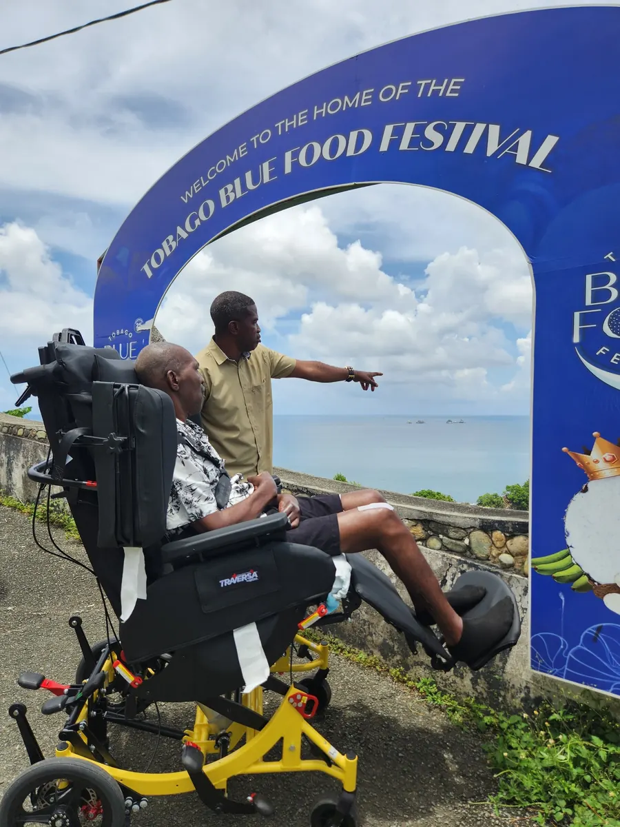 Wellness Express client using the Broda Traversa wheelchair while enjoying the Tobago Blue Food Festival