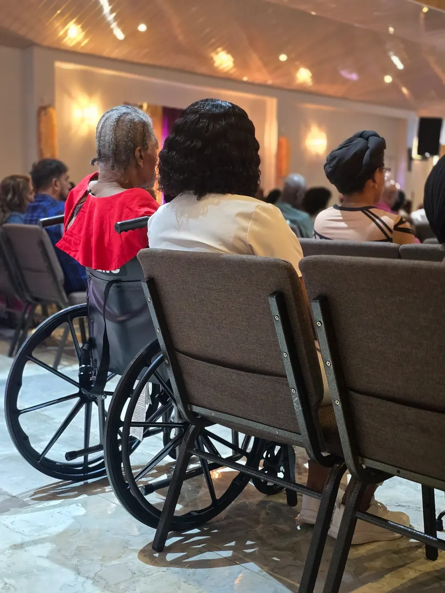 Wheelchair user attending a family event with accessible transportation support from Wellness Express